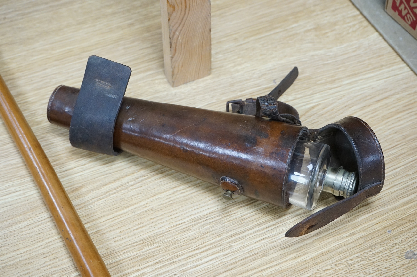 A riding crop with carved stag antler dog’s head handle together with a leather cased riding flask, 79cm. Condition - fair to good